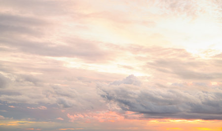 Dramatic overcast sky panorama with gray storm clouds during golden hour sunset creating moody atmospheric background for climate change awareness campaigns and emotional weather storytelling contentの写真素材