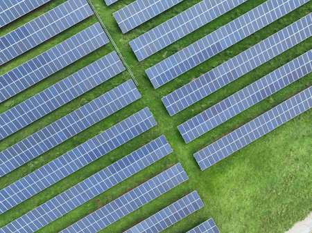 Aerial top view of expansive solar panel farm installation. Renewable energy technology and...