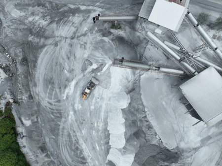 Aerial view of granite and limestone crushing plant with excavators processing raw stone into construction aggregates for concrete and infrastructure development. Stone mill factory.の写真素材