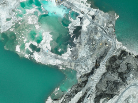 Open pit mine industry. Limestone quarry with backhoe and truck in operation. Heavy machinery in...