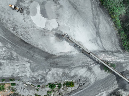 Aerial view of granite and limestone crushing plant with excavators processing raw stone into...