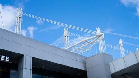 Modern steel cable structure above commercial building with clean architectural lines, showcasing...