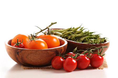 Fresh tomatoes and green beans on whiteの写真素材