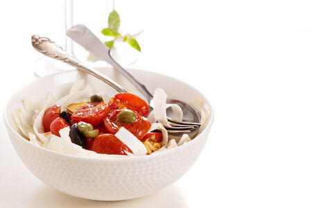 Celery root pasta with tomatoes, olives and capersの写真素材
