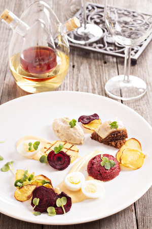 Gourmet salad with beet and herring on a plateの写真素材