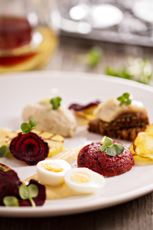 Gourmet salad with beet and herring on a plateの写真素材