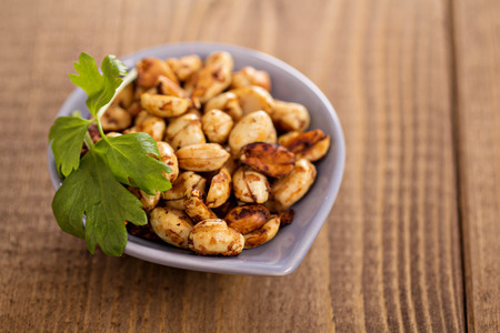 Spicy roasted peanuts in a small bowlの写真素材