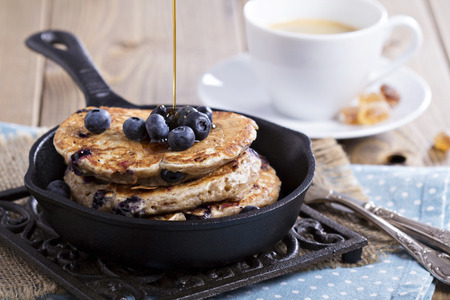 Eggless pancakes with banana and blueberries in a small panの写真素材
