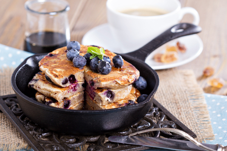 Eggless pancakes with banana and blueberries in a small panの写真素材