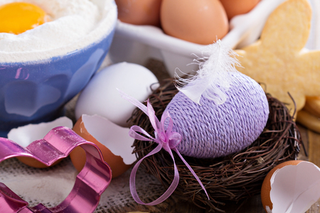 Decorative Easter egg in a nest with cookiesの写真素材