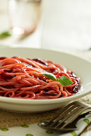 Pasta with caramelized beetroot served in a plate - selective focusの写真素材