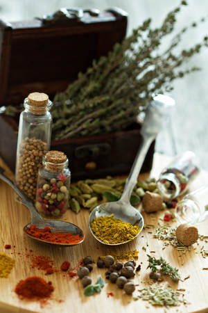 Variety of spices and herb on a wooden board - selective focusの写真素材