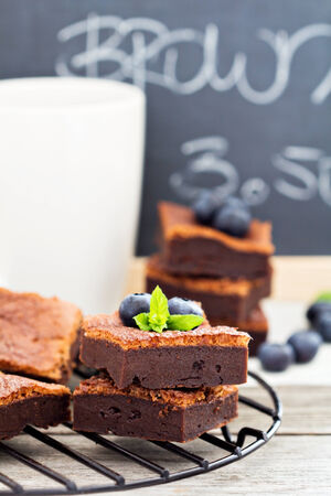 Stacked brownies with a cup of teaの写真素材