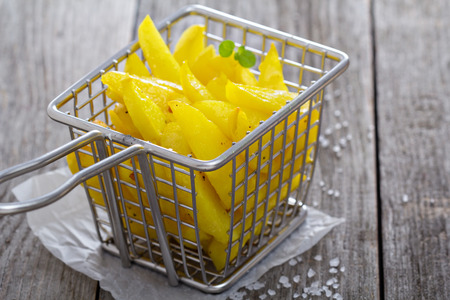 Homemade french fries in a frying basket