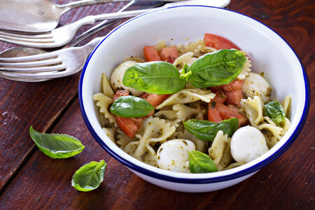 Pasta salad Caprese style with farfalle, tomato and mozarellaの写真素材