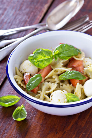 Pasta salad Caprese style with farfalle, tomato and mozarellaの写真素材