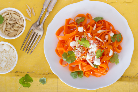 Carrot pasta salad with feta and almondsの写真素材