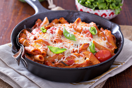 Pasta bake with penne, tomatoes and mozarellaの写真素材