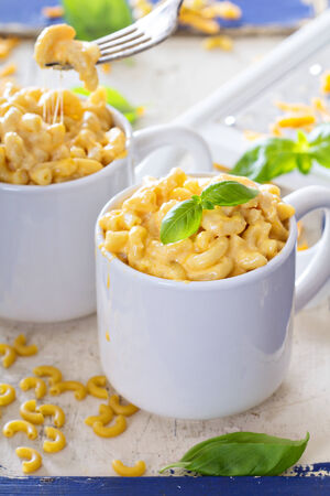 Macaroni and cheese served in mugsの写真素材