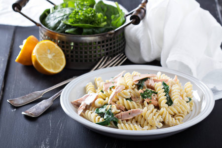Pasta fusilli with baked salmon and spinachの写真素材