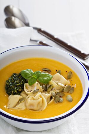 Pumpkin cream soup with cheese tortelliniの写真素材