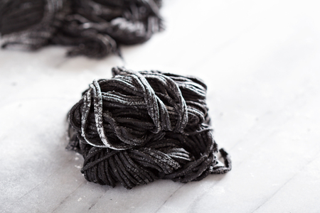 Squid ink homemade pasta on marbleの写真素材