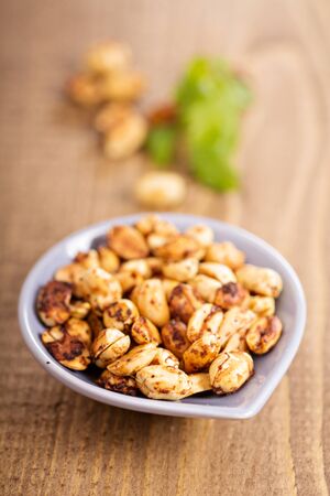 Roasted spicy hot peanuts in small dishの写真素材