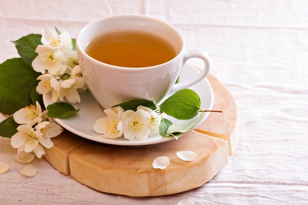 Jasmine tea in a cup with fresh jasmine flowersの写真素材