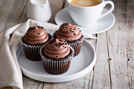 Chocolate cupcakes with a cup of hot black coffee