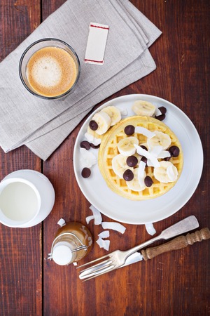 Waffles with banana slices, caramel and chocolateの写真素材