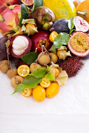 Variety of exotic fruits on white tableの写真素材