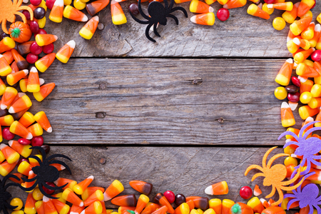 Halloween candy frame around rustic board empty space for your textの写真素材