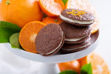 Chocolate orange thin brownie cookies with cream fillingの写真素材