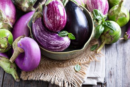 Eggplants of different color and variety on the tableの写真素材