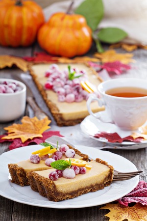 Pumpkin tart on gingerbread crust with candied cranberryの写真素材