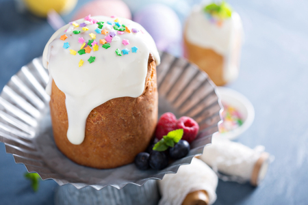 Traditional Easter yeasted cake with white glaze and colorful sprinkles