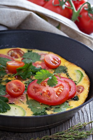 Fresh fritatta with zucchini, spinach and tomatoesの写真素材
