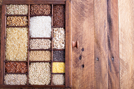 Variety of healthy grains and seeds in a wooden boxの写真素材