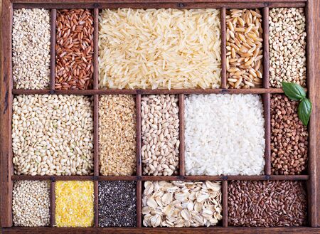 Variety of healthy grains and seeds in a wooden boxの写真素材