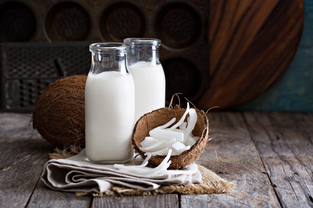Coconut vegan milk non dairy in different bottles with copy spaceの写真素材