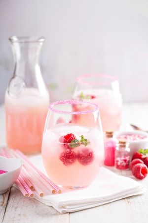 Raspberry lemonade with ice in a glassの写真素材