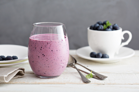 Blueberry banana pomergranate smoothie in a glassの写真素材