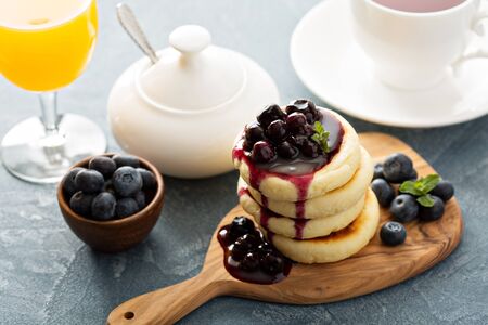 Small cottage cheese pancakes with blueberry sauceの写真素材