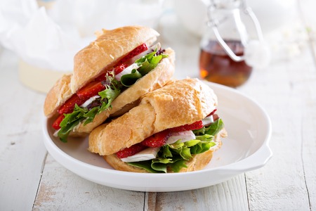 Croissant sandwich with brie cheese, salad and strawberryの写真素材