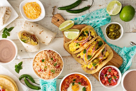 Variety of colorful mexican cuisine breakfast dishes on a tableの写真素材