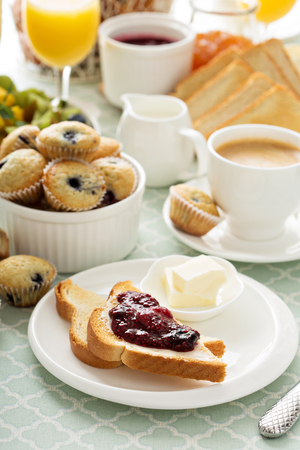 Fresh and bright continental breakfast table with jam on toast