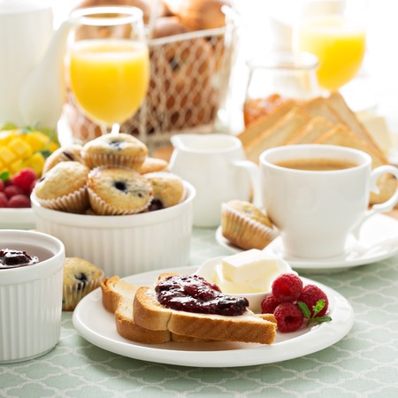 Fresh and bright continental breakfast table with jam on toast