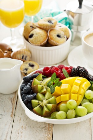 Fresh and bright continental breakfast table with fruit plateの写真素材
