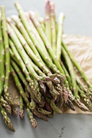 Fresh green raw asparagus stalks on the tableの写真素材