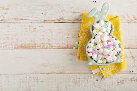 Easter background with mini marshmallows in bunny plateの写真素材